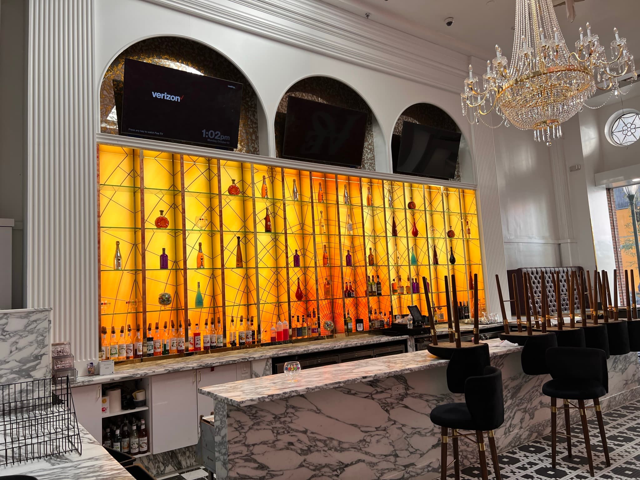 Amber bar wall, chandelier and marble in the finished Philadelphia location