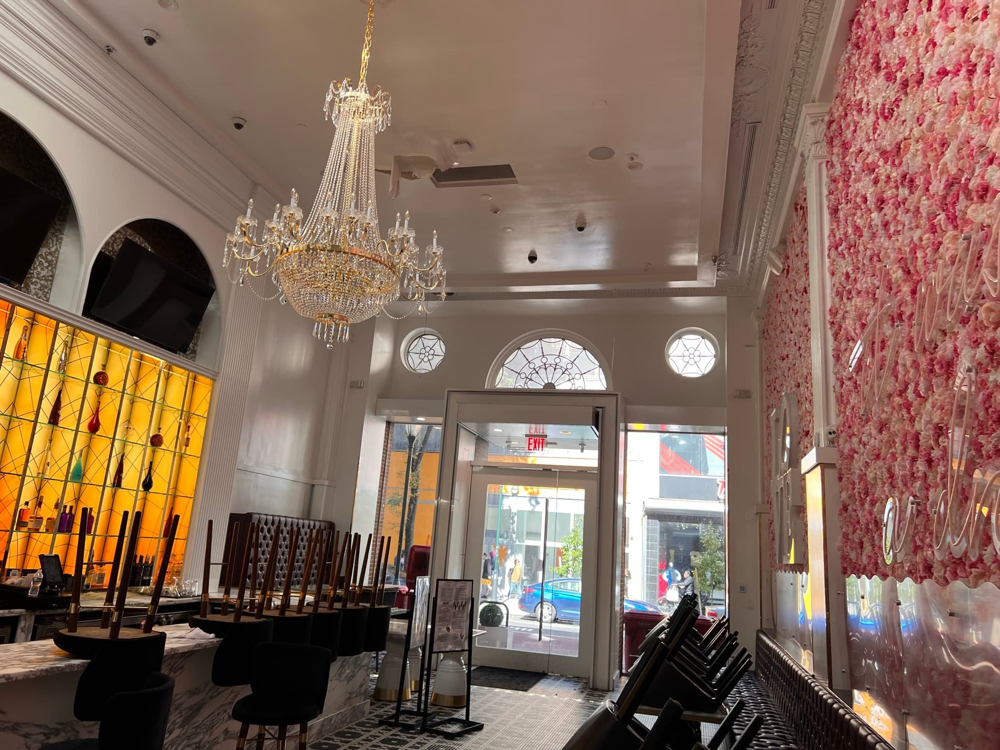 Sugar Factory: Chandelier, amber bar, flower wall and entrance in one view