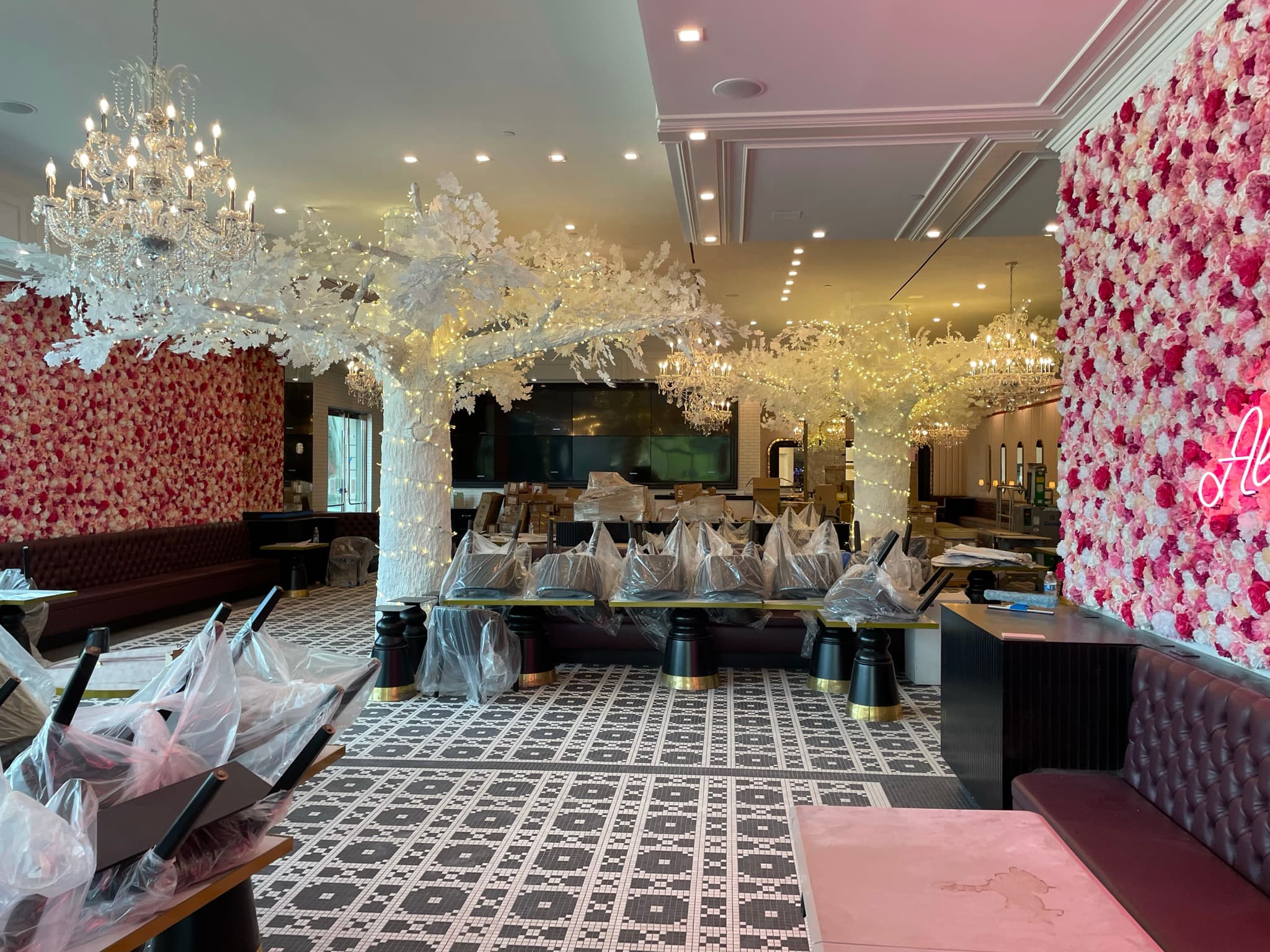 Sugar Factory: Wide view of the finished dining room, with blossom trees, chandeliers and flower walls
