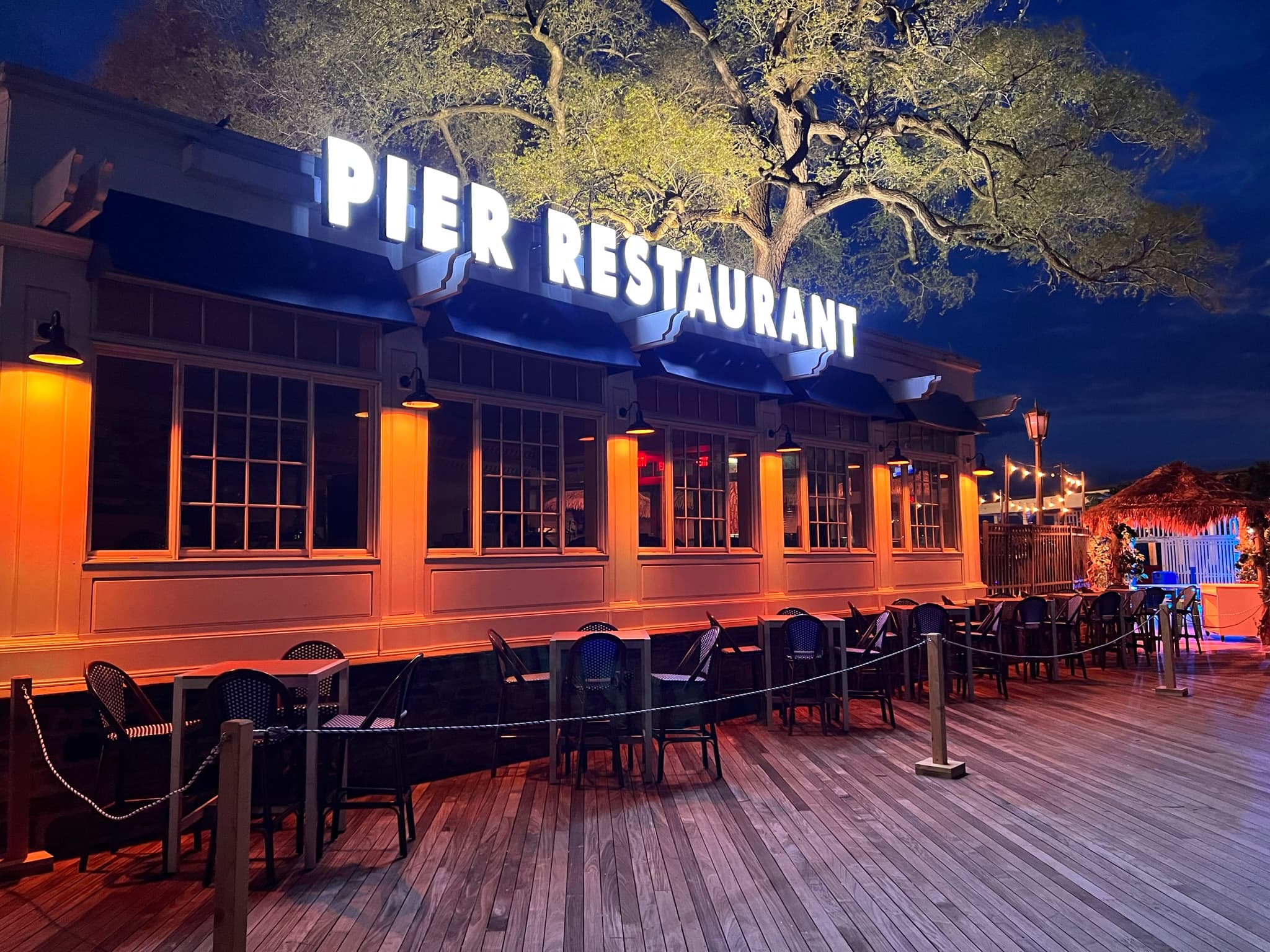 Tiki Beach Pier at night with lit signage